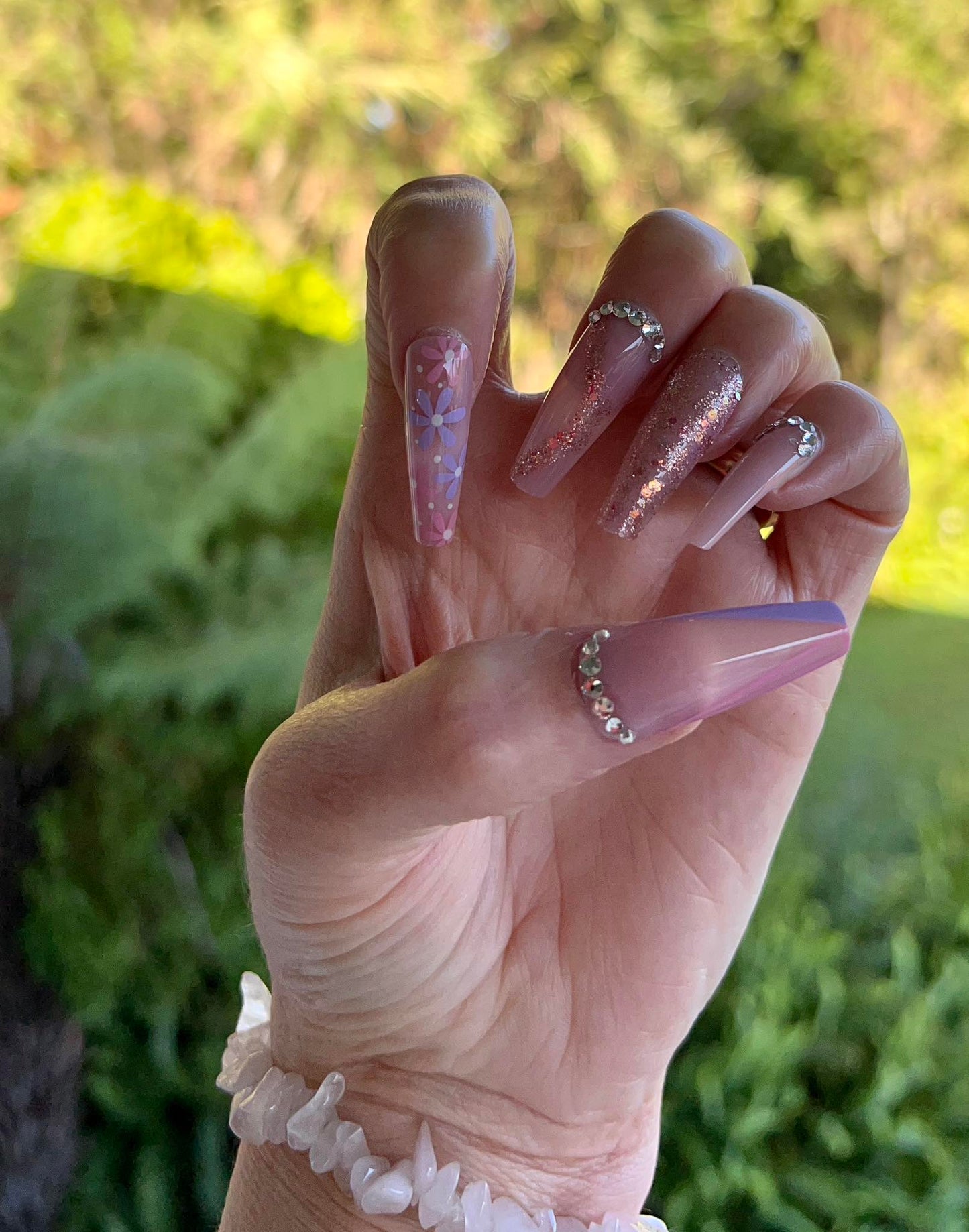 Long Coffin Press on Nails. Pink & Lilac with Flowers & Jewels. Easy and quick to apply. Great for those special occasions, parties or add an edge to any outfit. Gorgeous, flattering and you can re-use them again and again.
