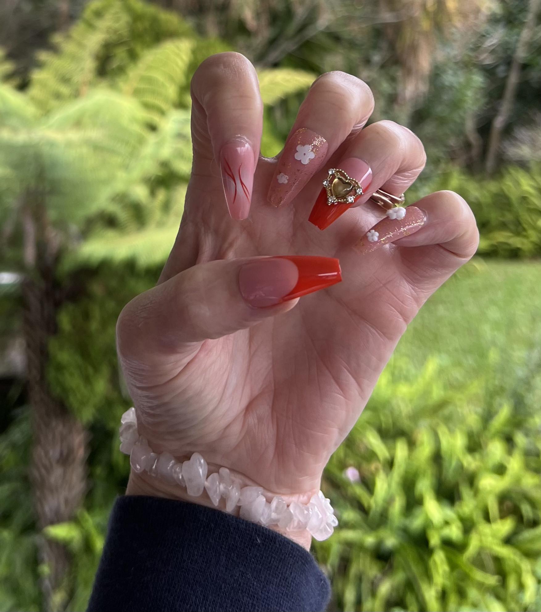 Long Coffin Press on Nails. Orange, Clear & Frosted with Glitter, Jewels, Hearts & Flowers. Easy and quick to apply. Great for those special occasions, parties or add an edge to any outfit. Gorgeous, flattering and you can re-use them again and again.