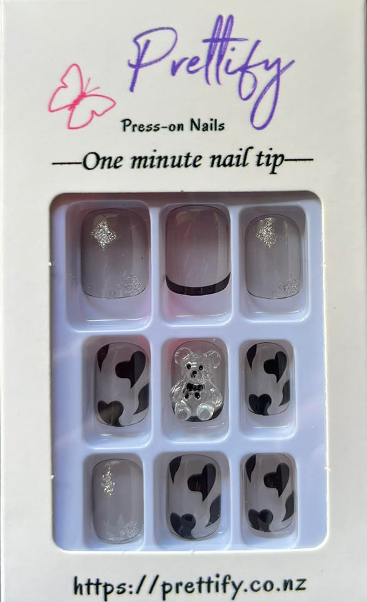 Medium Length Squoval Press on Nails. Clear Grey with Black Hearts, Glitter Stars & Teddy Bears. Durable Acrylic Press on Nails. Easy and quick to apply. Great for those special occasions, parties or add an edge to any outfit. Gorgeous, flattering and you can re-use them again and again.