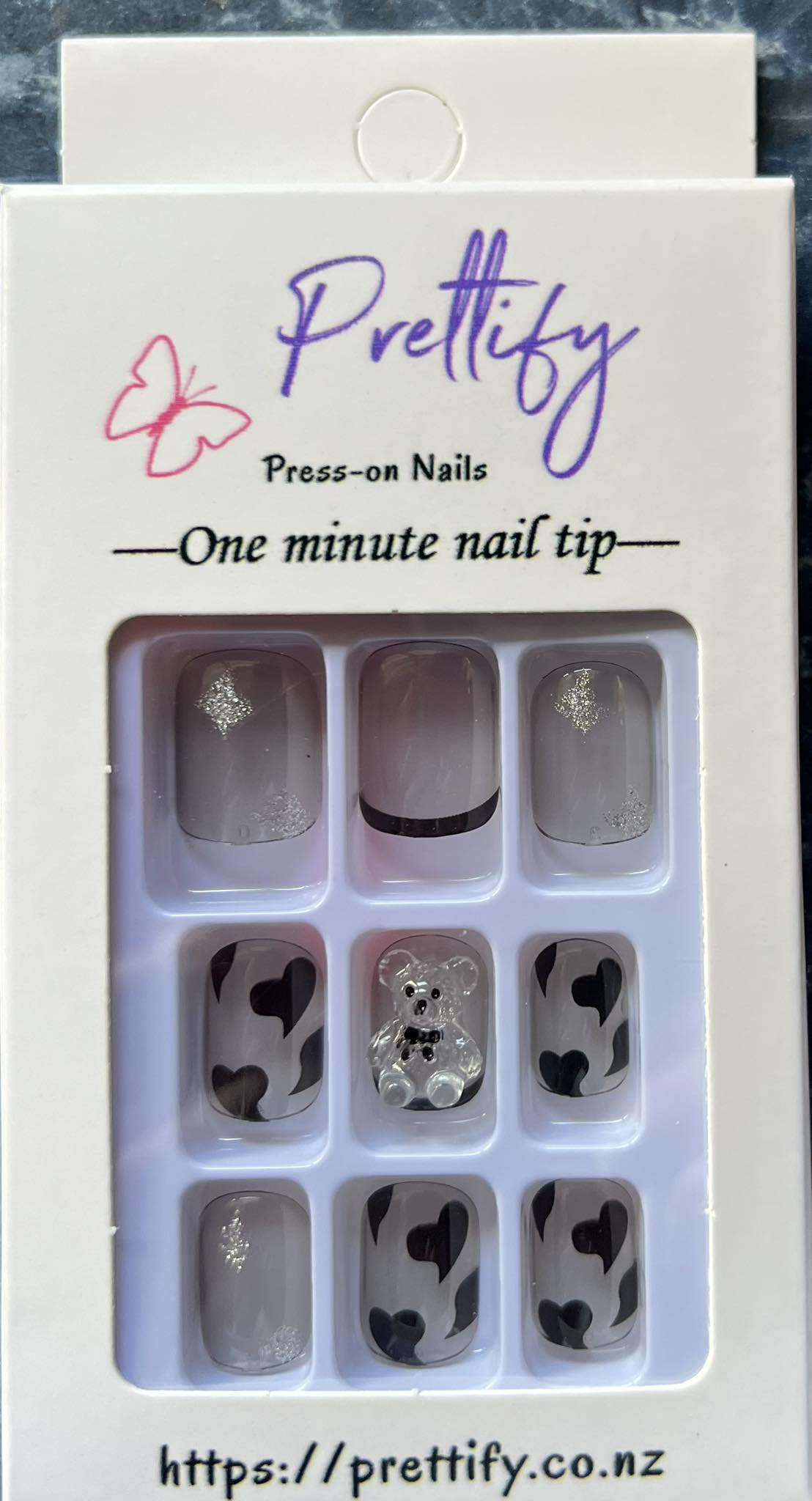 Medium Length Squoval Press on Nails. Clear Grey with Black Hearts, Glitter Stars & Teddy Bears. Durable Acrylic Press on Nails. Easy and quick to apply. Great for those special occasions, parties or add an edge to any outfit. Gorgeous, flattering and you can re-use them again and again.