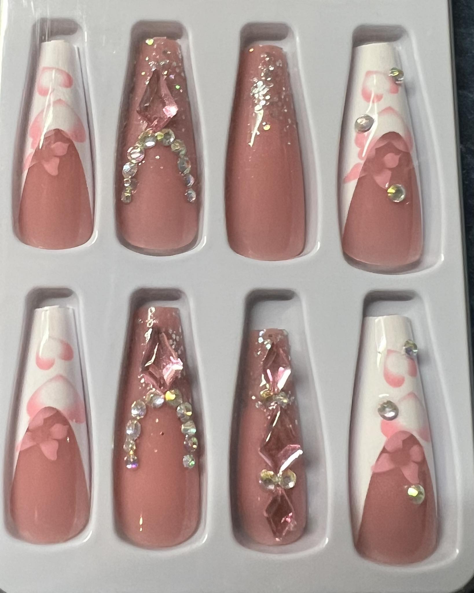 Long Coffin Press on Nails. White Tips with Pink Hearts & Butterflies & Clear with Jewels. Easy and quick to apply. Great for those special occasions, parties or add an edge to any outfit. Gorgeous, flattering and you can re-use them again and again.