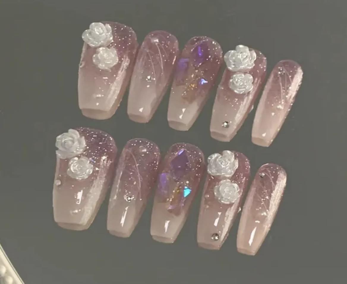 Medium Length Coffin Press on Nails. Cream/Taupe Ombre with Lilac Jewels & Glitter and White 3D Roses. Durable Acrylic Press on Nails. Easy and quick to apply. Great for those special occasions, parties or add an edge to any outfit. Gorgeous, flattering and you can re-use them again and again.