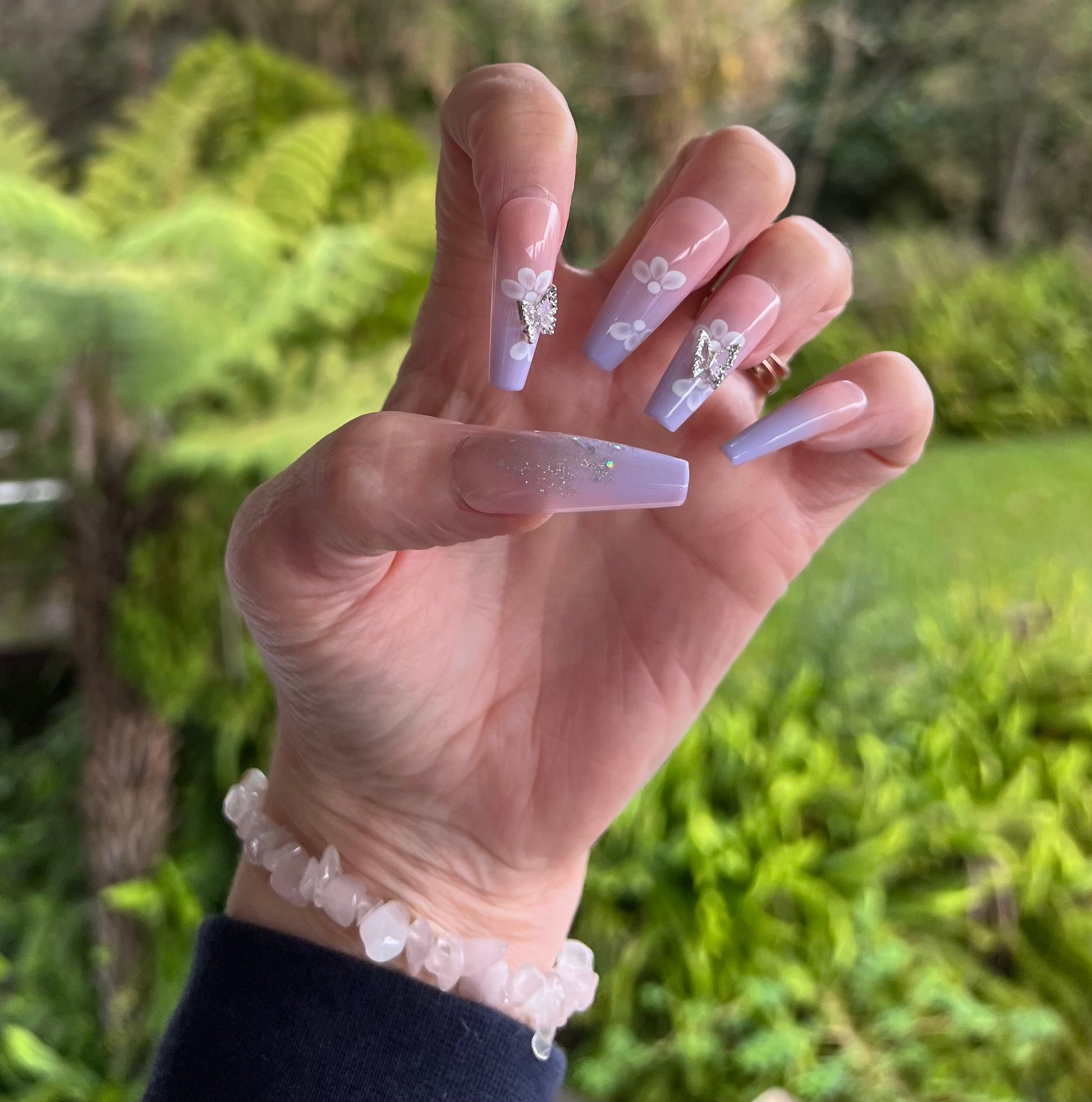Long Coffin Press on Nails. Lilac & Pale Pink with Glitter, Silver 3D Butterflies & White Flowers. Durable Acrylic Press on Nails. Easy and quick to apply. Great for those special occasions, parties or add an edge to any outfit. Gorgeous, flattering and you can re-use them again and again.